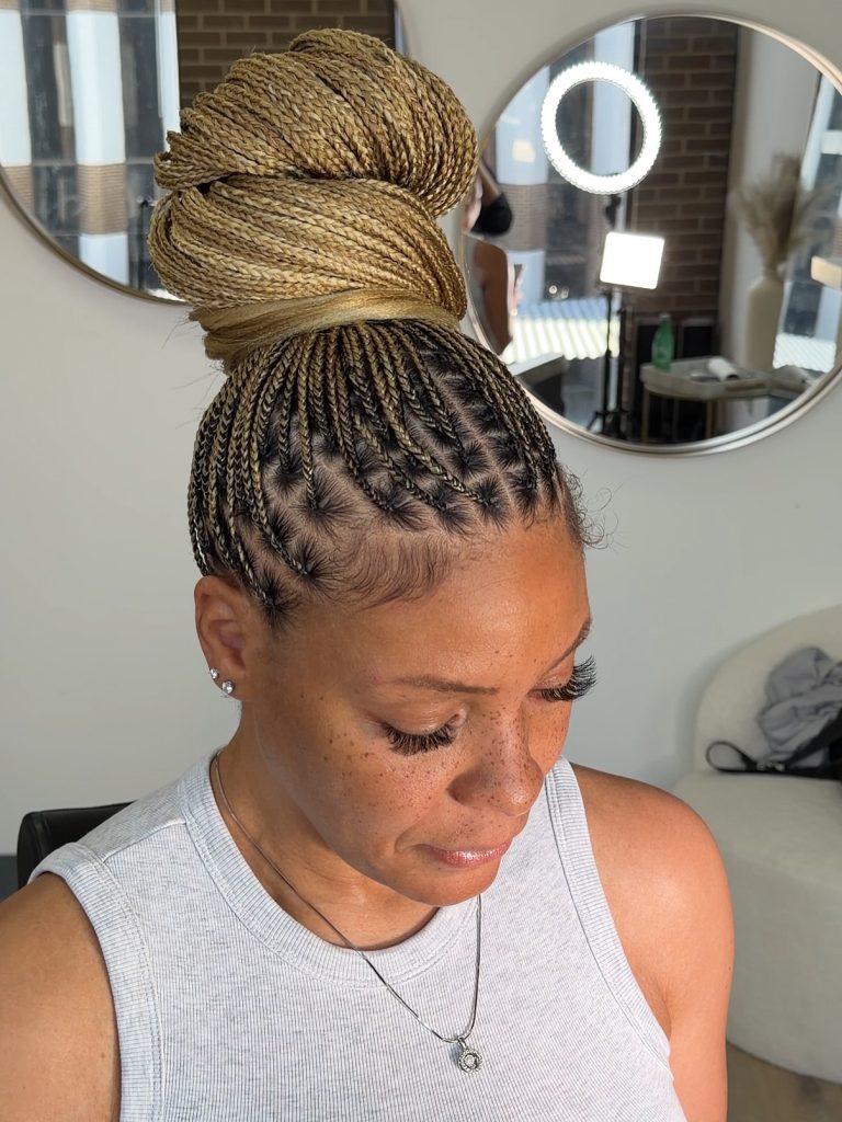 blonde mix small knotless braids in a bun