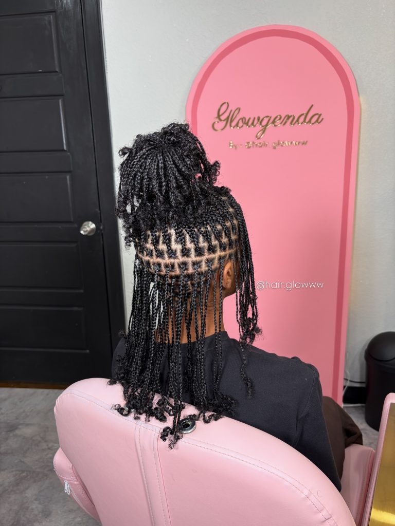 natural hair mini braids with curly ends in a messy high ponytail with bangs