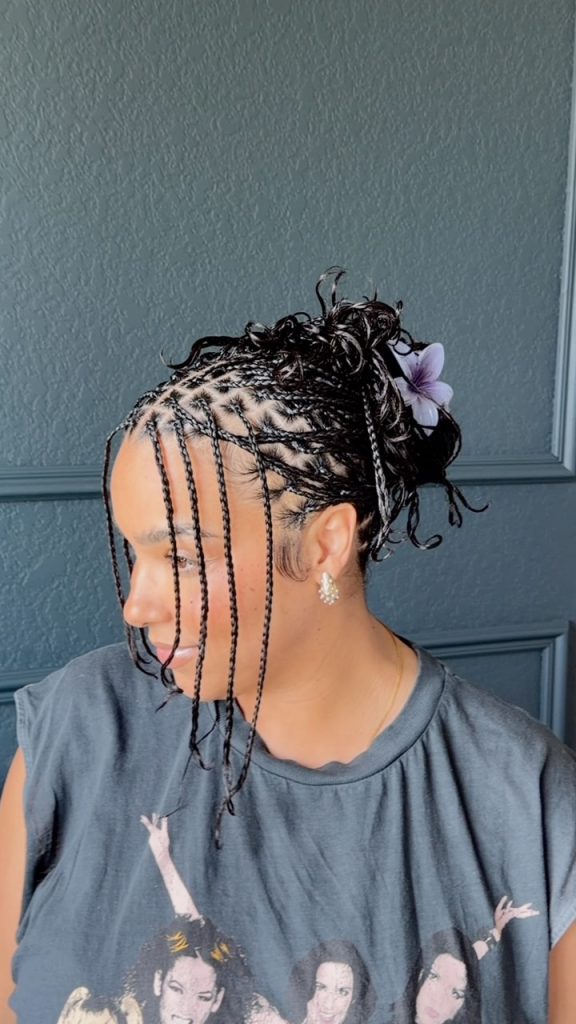 long natural hair mini braids styled with a lavender lfower claw clip